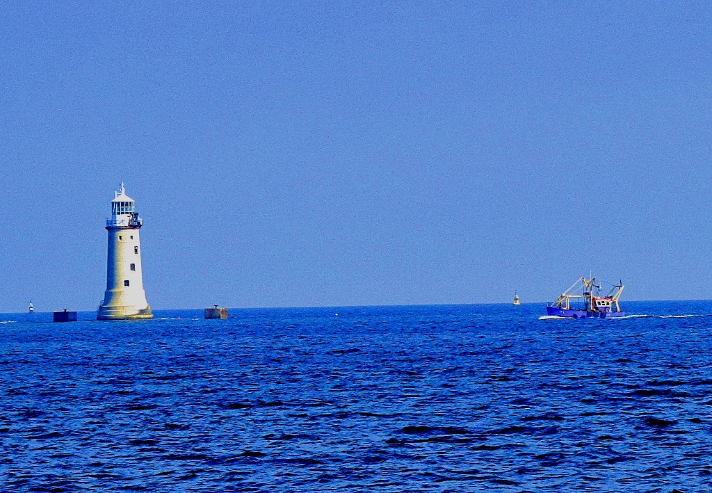 Lighthouse and fishing boat